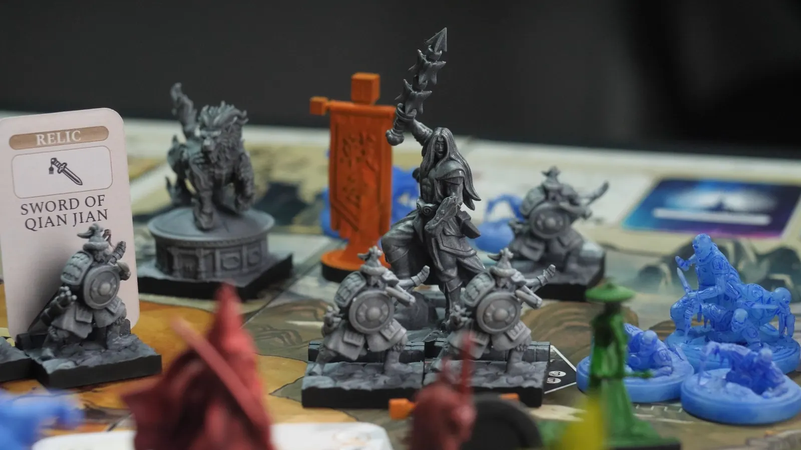 Grey shield-bearing warriors around their leader, beside the Sword of Qian Jian relic card