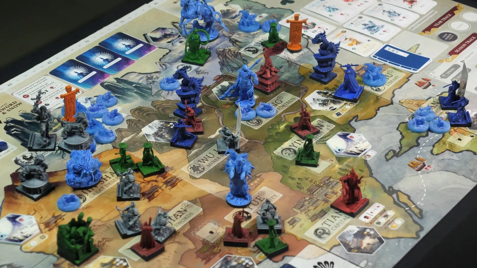 The whole board in the middle of a game, crowded with miniatures from every faction